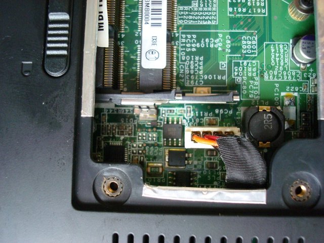 Disconnect the power board cable from the main board on the bottom side